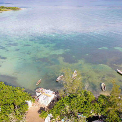 An overhead photograph of the ocean, dotted with boats.