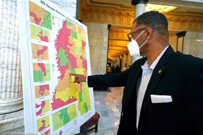 Sen. Sollie Norwood, D-Jackson points out his district on a poster-sized map in the Capitol rotunda in Jackson, Mississippi