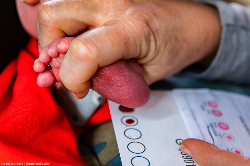 A newborn heel prick being performed.