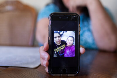 Celia Banos holding a photo of Jhean.