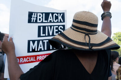 Protester holding "#Black Lives Matter" sign