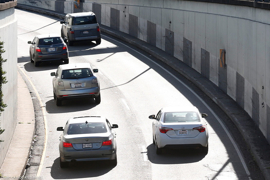 Cars spilling out of the Webster Street Tube in Alameda, California.