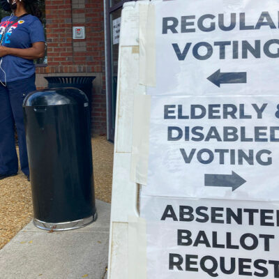 A sandwich board with directions posted on signs showing the way to vote outside a Cobb County voting building in Marietta, Ga.