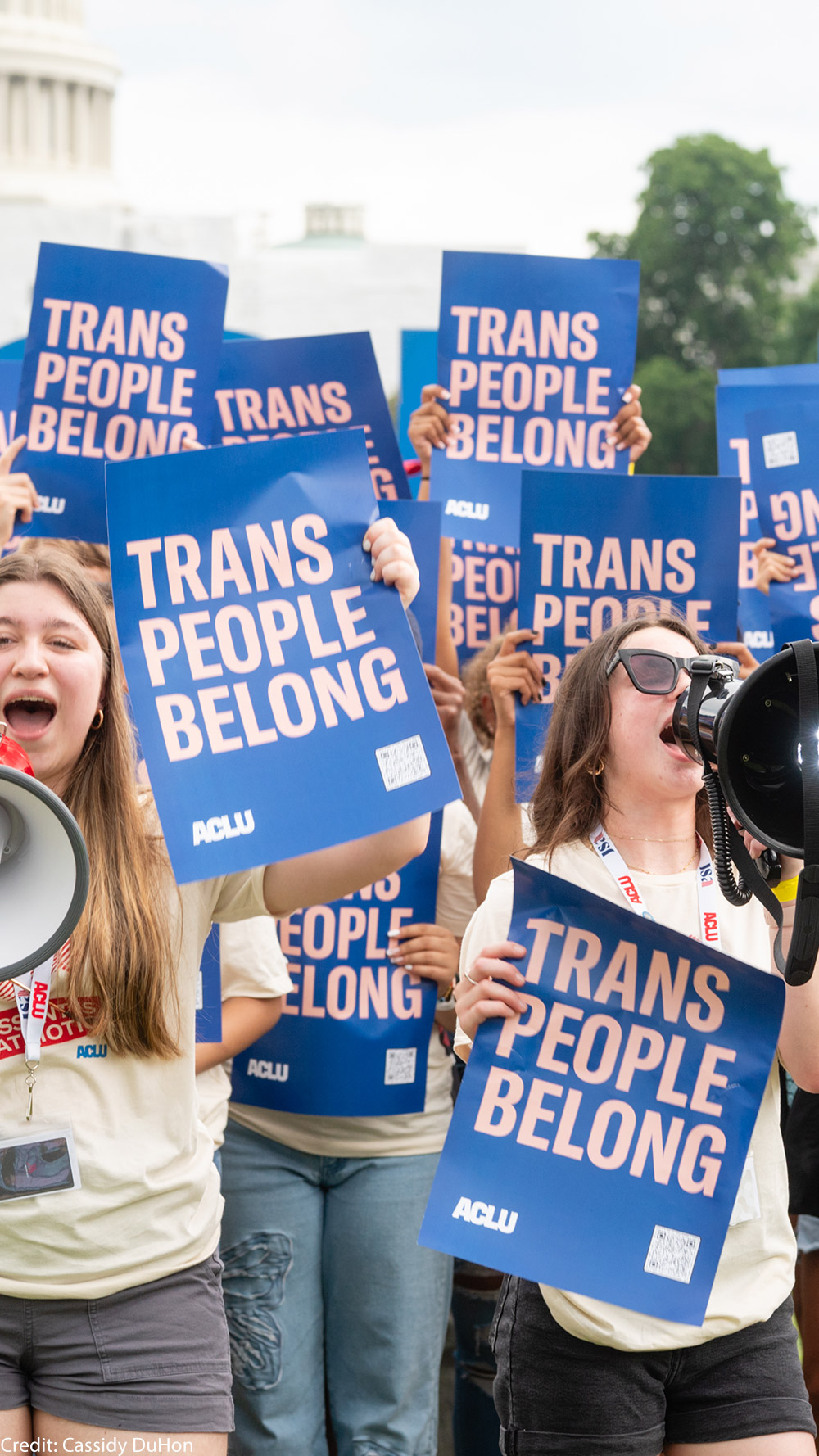 A group of young demonstrators holding ACLU signs that say Trans People Belong.
