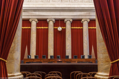 The vacant interior of the US Supreme Court with the justices' equally vacant seats.