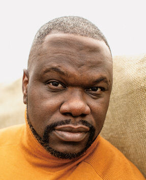 Headshot of poet and activist Ian Manuel with a neutral expression.