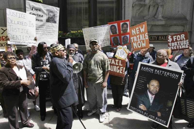 A group of demonstrators rally outside Chicago's City Hall