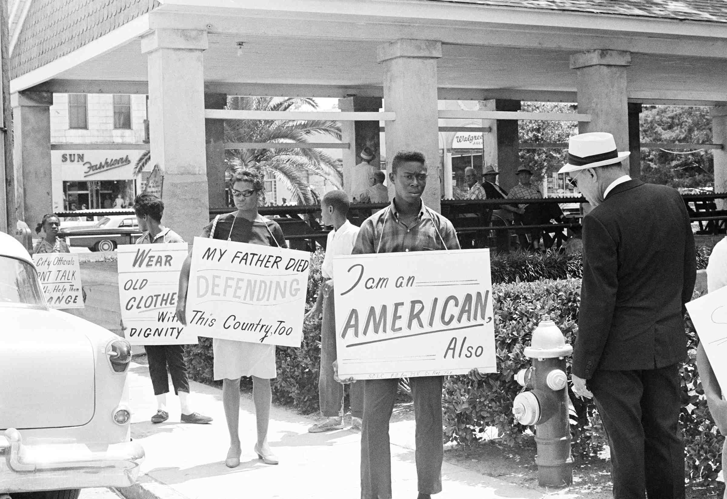 Demonstrators march in front of the old slave market, May 30, 1964, St. Augustine, Fla.