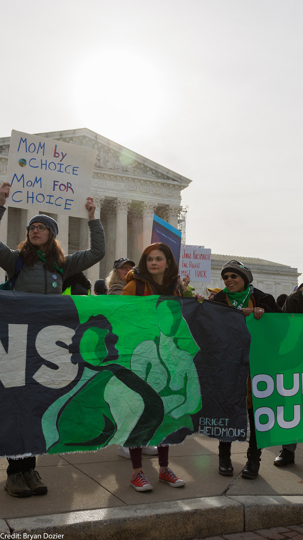 A group of demonstrators holding a banner saying "Our Bodies, Our Freedom."
