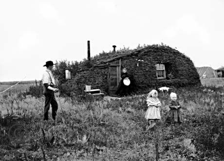 Norwegian immigrants in front of a sod house (Wikimedia)