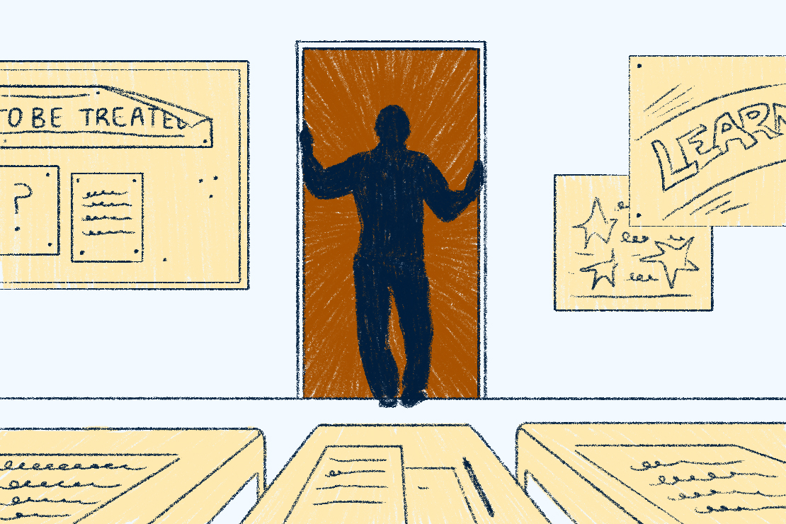 An individual in a classroom looking out at an open entranceway.