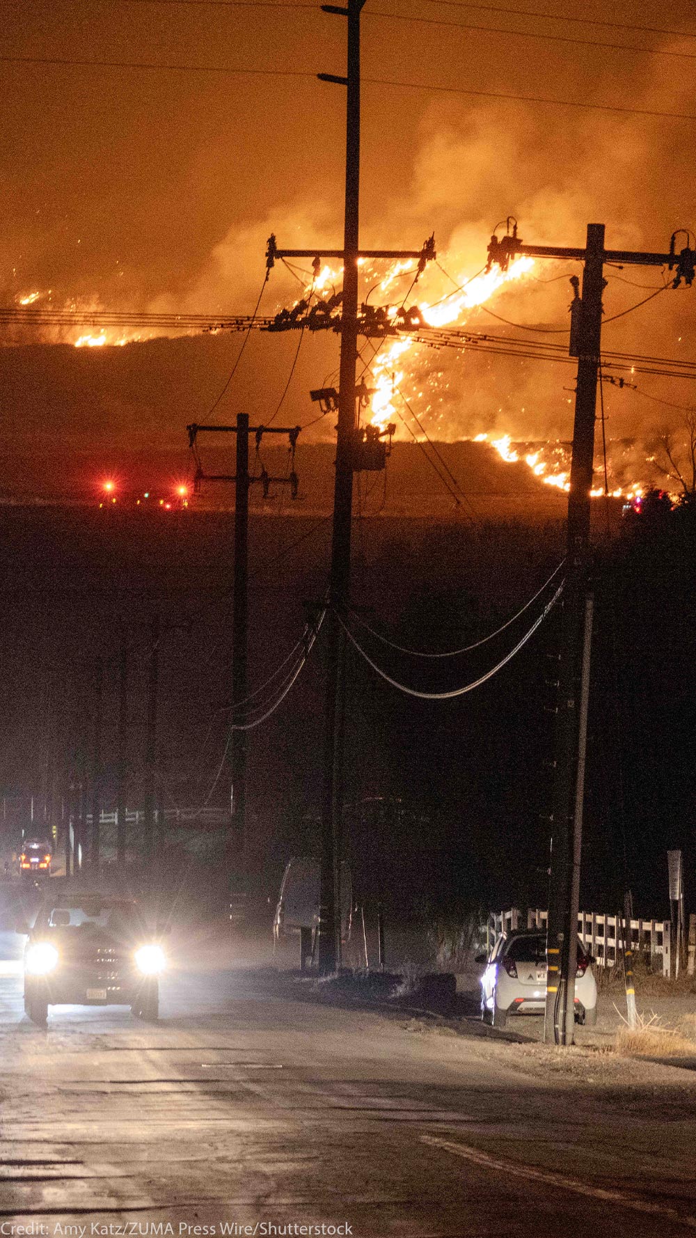 Hughes fire, in Castaic, burns on a hill threatening the freeway below while cars attempt to escape.
