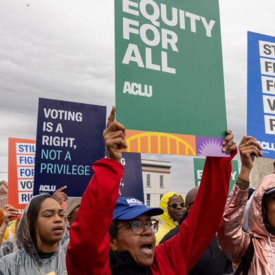 A group of voting rights advocates marching over the Edmund Pettus Bridge.