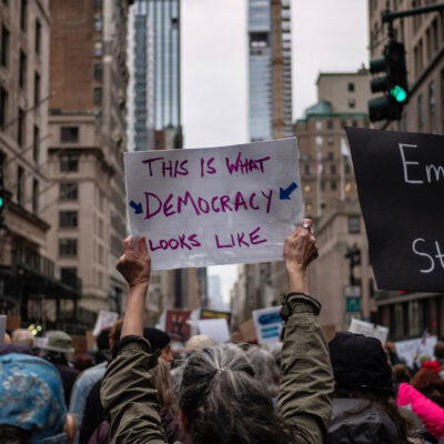 A group of demonstrators in Manhattan holding pro-democracy signage.