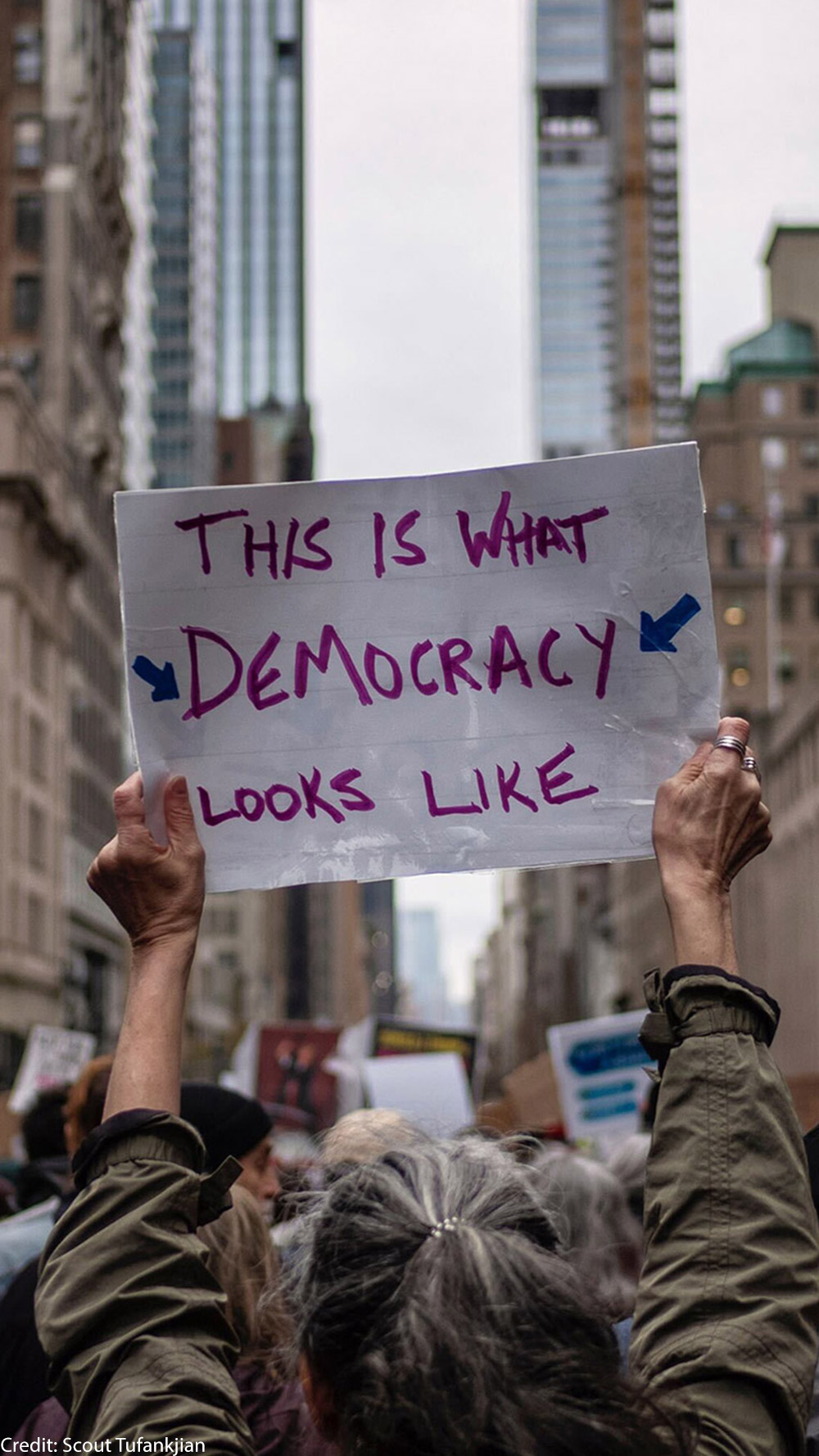 A group of demonstrators in Manhattan holding pro-democracy signage.