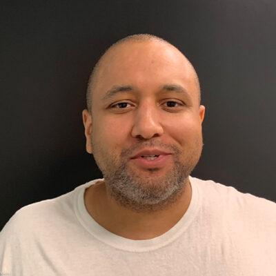 Mikal Mahdi headshot wearing a white tee shirt.