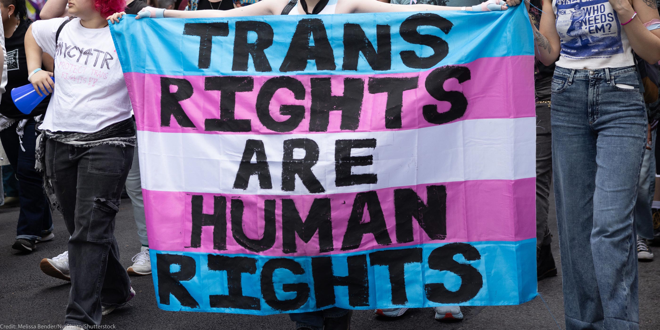 Trans Rights, speakers, protesters, and supporters denounce the Trump Administration's persistent attacks on the transgender community. by carrying a huge sign reading" TRANS RIGHTS ARE HUMAN RIGHTS".