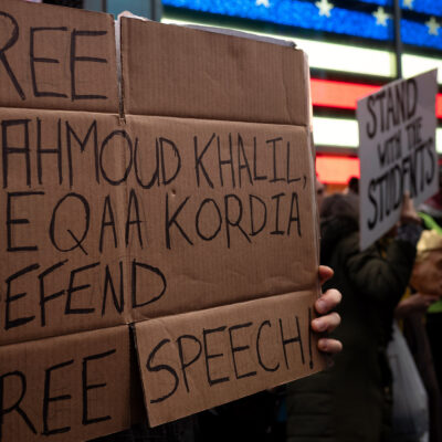 A demonstrator holding a sign in support of freeing activist Mahmoud Khalil.