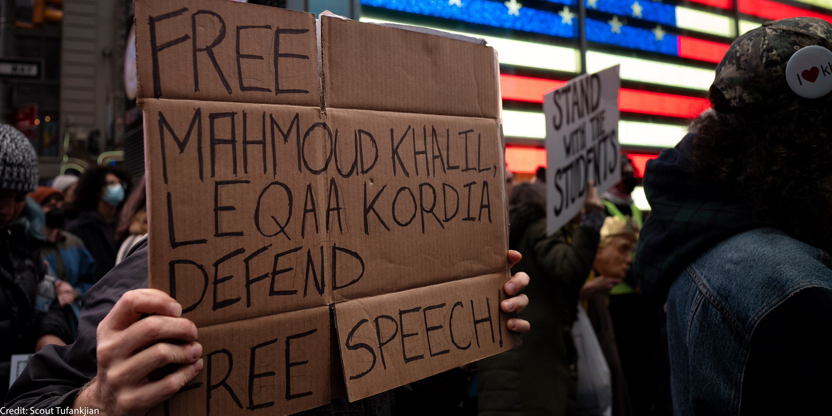 A demonstrator holding a sign in support of freeing activist Mahmoud Khalil.