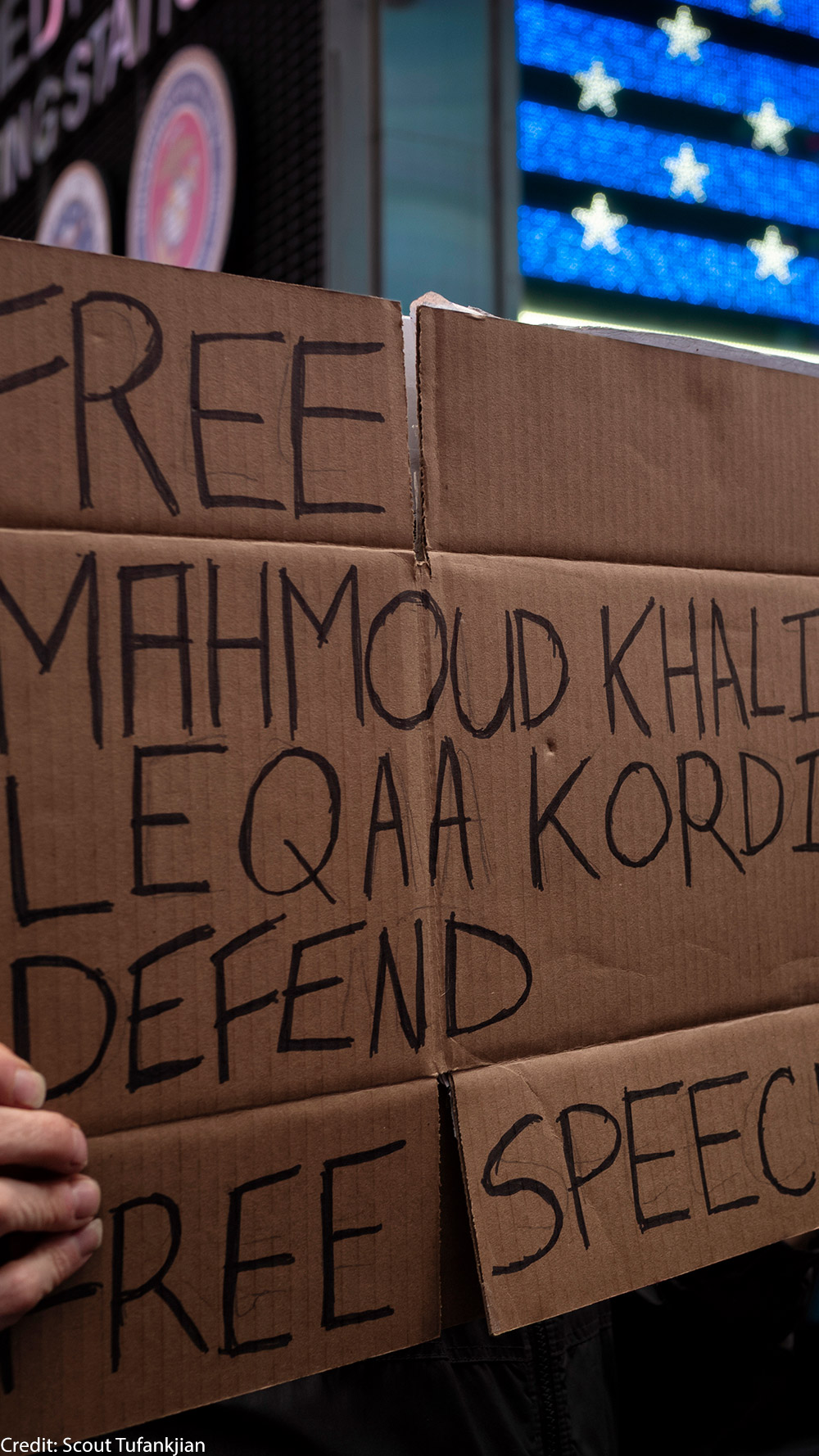 A demonstrator holding a sign in support of freeing activist Mahmoud Khalil.