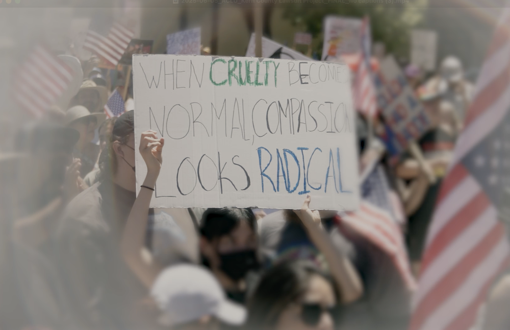 A demonstration sign that say "When Cruelty Becomes Normal, Compassion Looks Radical."