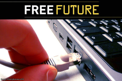 Two fingers disconnecting a network cable from a computer