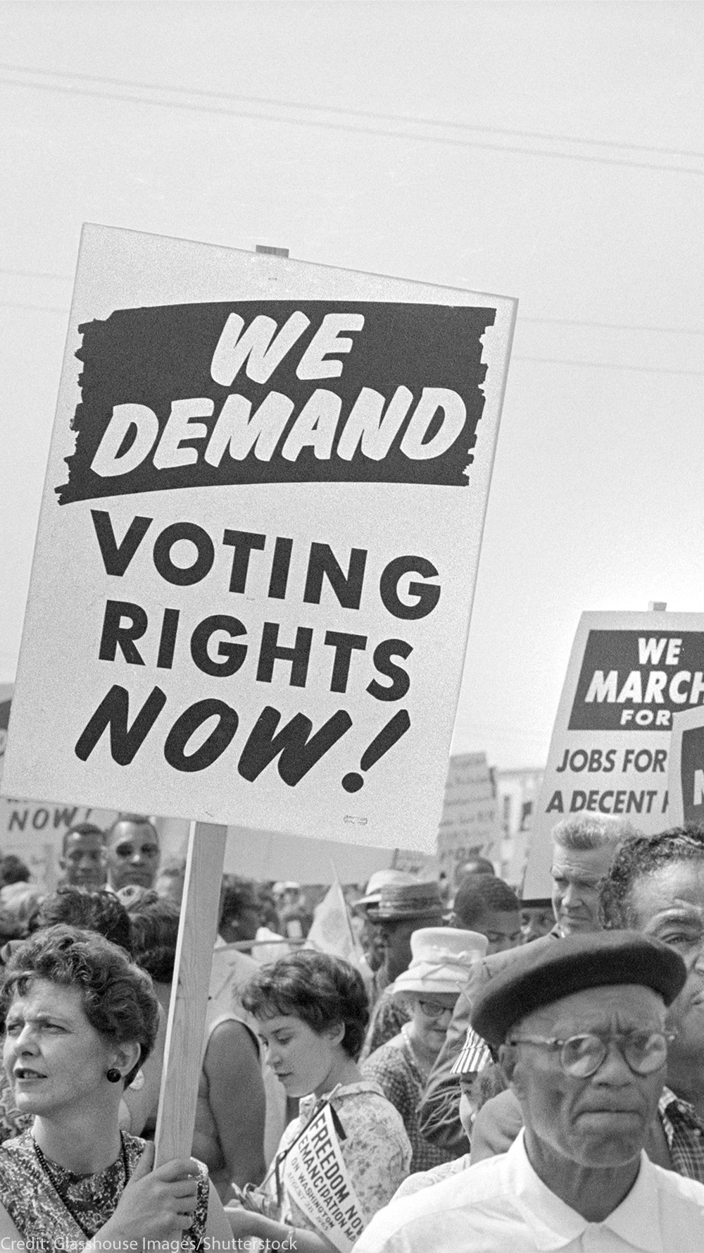 Protesters with signs at march on Washington, D.C. for Jobs and Freedom, carrying signs that read "WE DEMAND VOTING RIGHTS NOW!" and WE DEMAND AN END O POLICE BRUTALITY NOW!" on August 28, 1963.