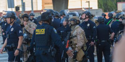 Border Patrol agents and police congregating during during a demonstration against expanded ICE operations and in support of immigrant rights.