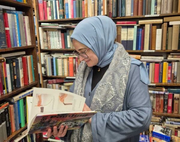 Rumeysa Ozturk reading a children's book in a bookstore.