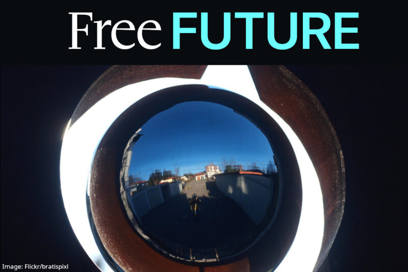 A closup of big camera eye with a house walkway reflected in the lens