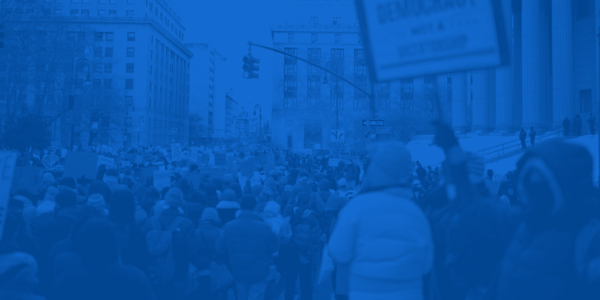 blue background with crowds of people at protest